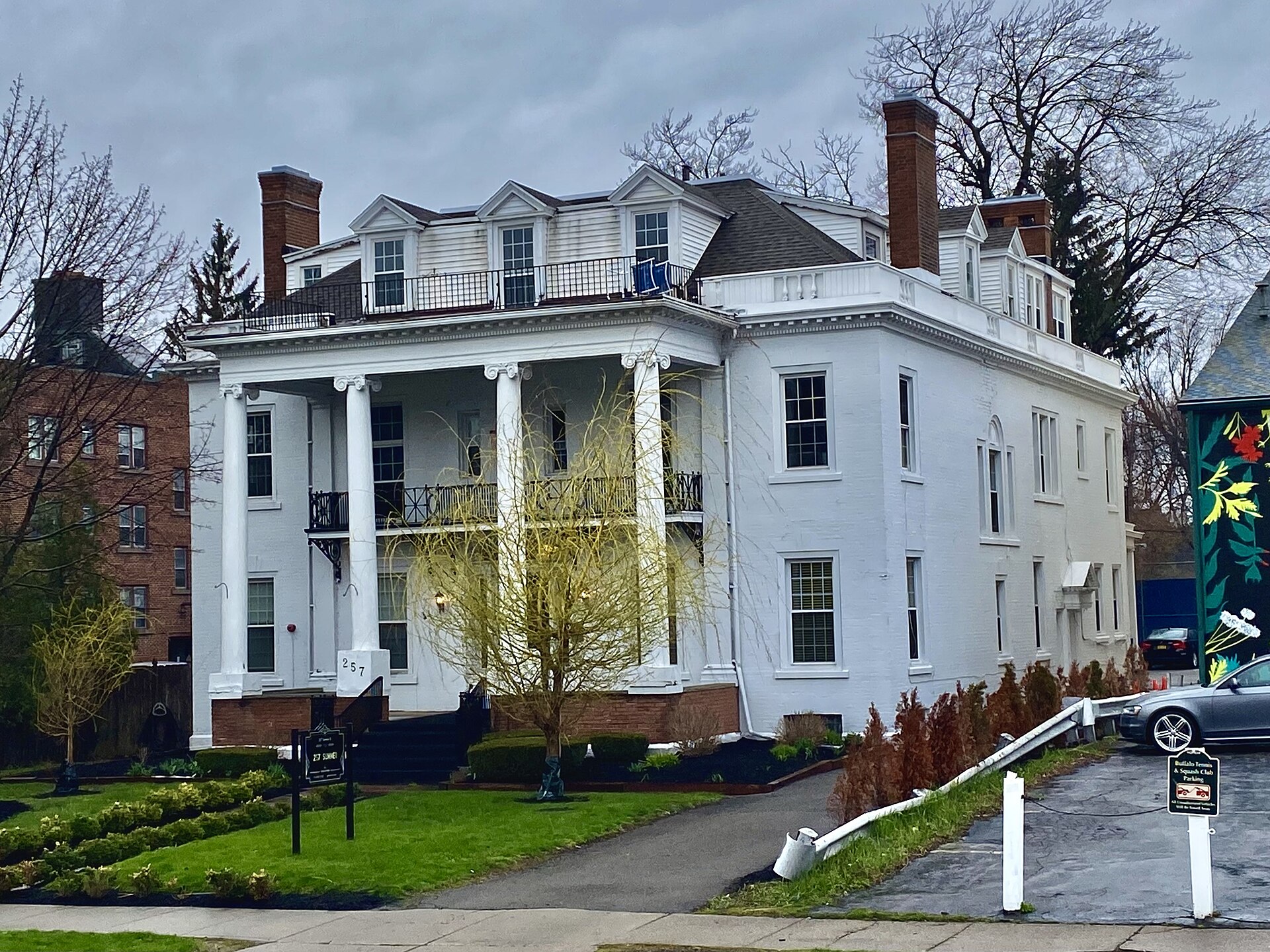 Classical pediment-and-fanlight entries are a Colonial Revival staple