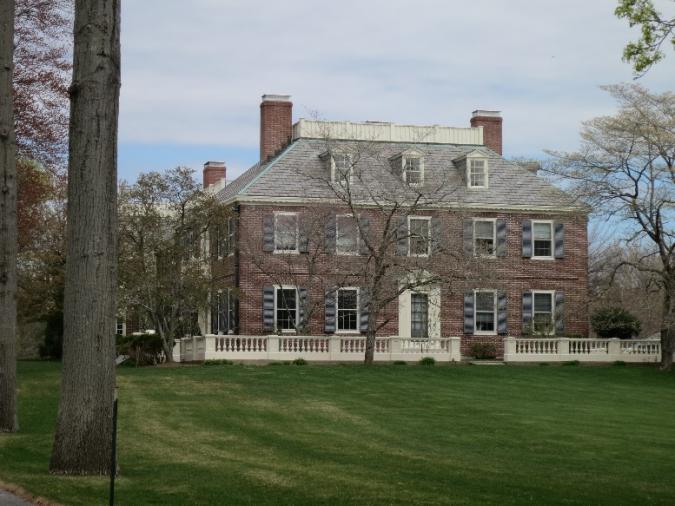 The symmetrical five-bay facade with center entry, the Colonial Revival ideal