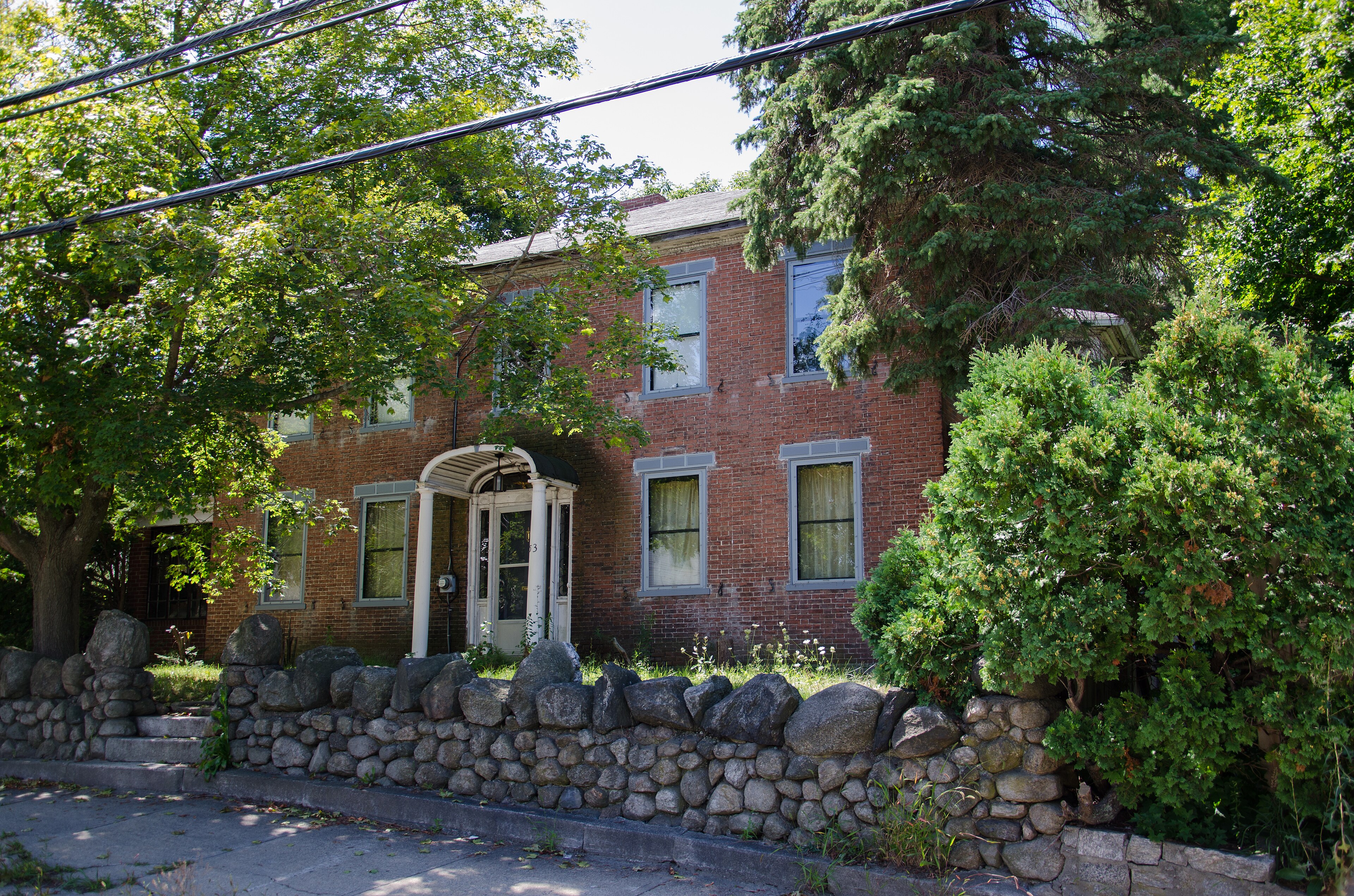 A Federal-era brick rowhouse on Beacon Hill, with semi-elliptical fanlight