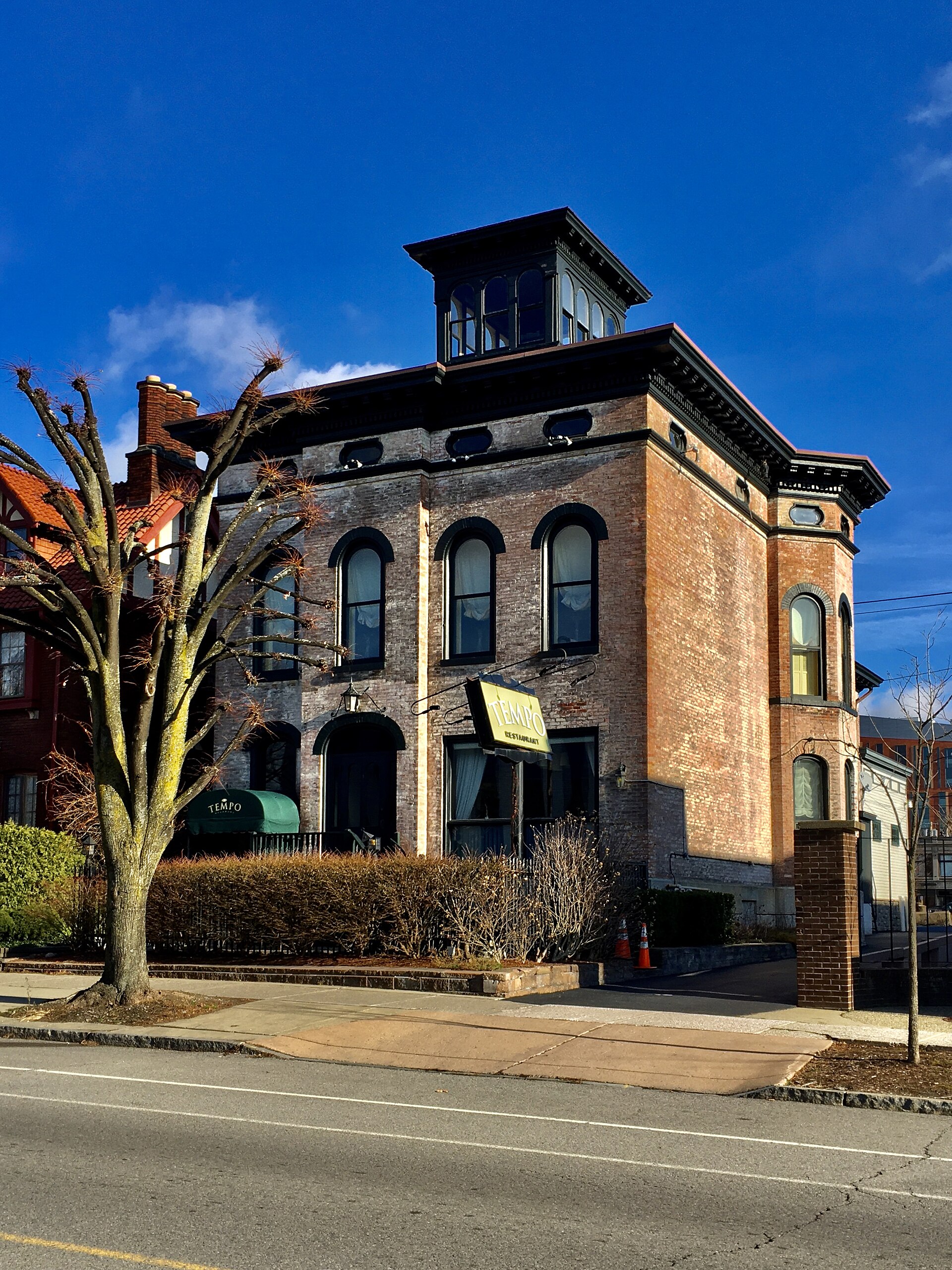A rooftop cupola crowning the low-hipped Italianate roof